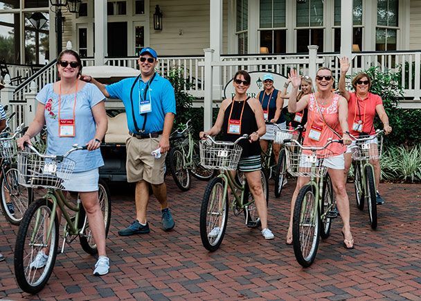 A group of people ready for a bicycle ride at a Connoisseurs Connections Conference.