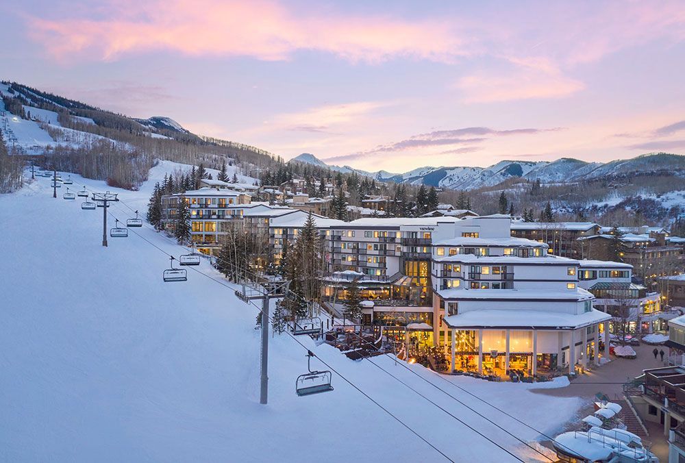 Viewline Resort Snowmass ski lift behind resort, in winter at sunset