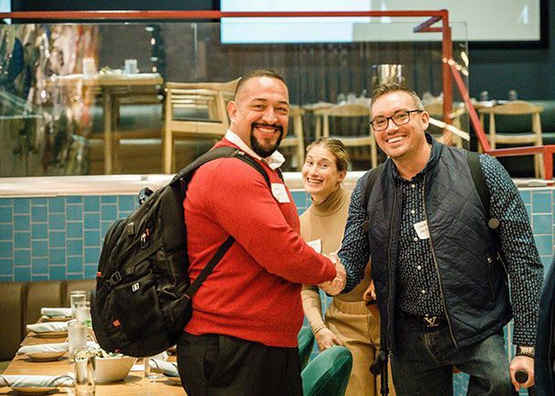 Two men shaking hands during a Retreats Resources roadshow.